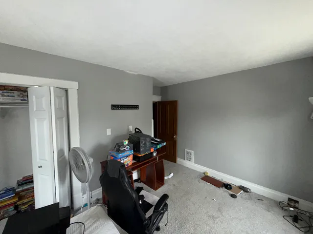 a living room with furniture a lamp and a large window