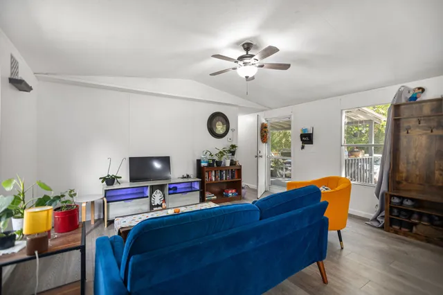 a living room with furniture and wooden floor