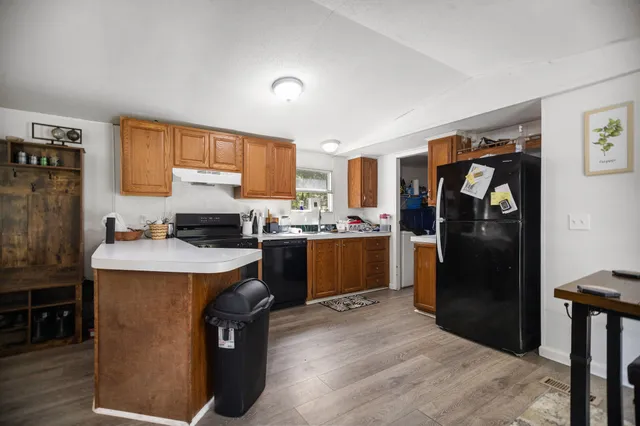 a kitchen with a refrigerator and furniture