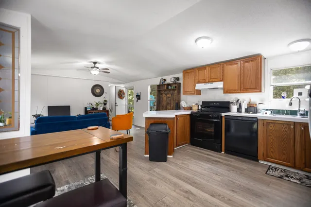 a view of a hallway with wooden floor and closet