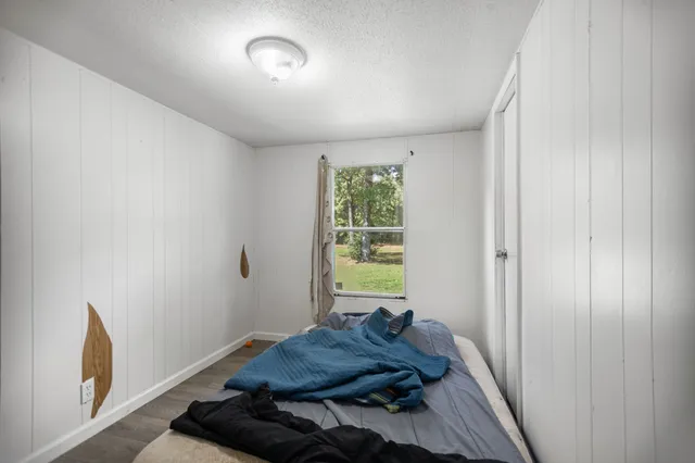 a view of small space with wooden floor and a window