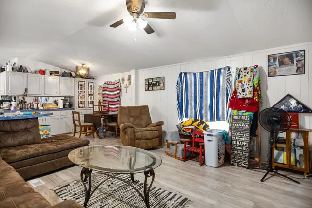 a living room with furniture and kitchen view