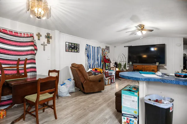 a view of a kitchen with a stove and a chandelier