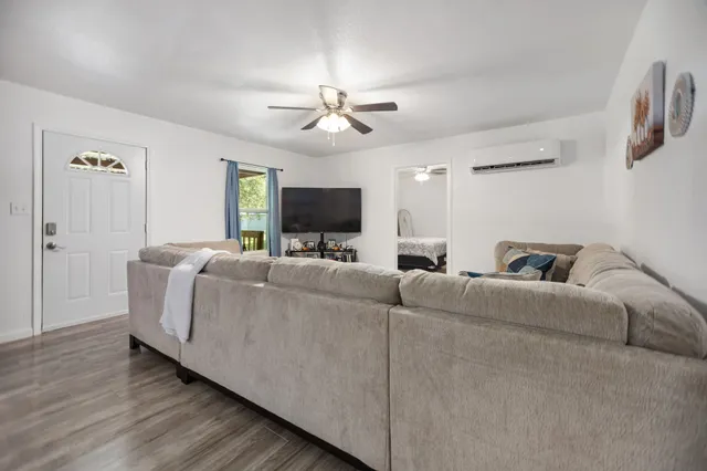 a living room with furniture and a flat screen tv