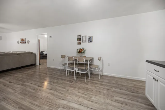a dining room with furniture and wooden floor