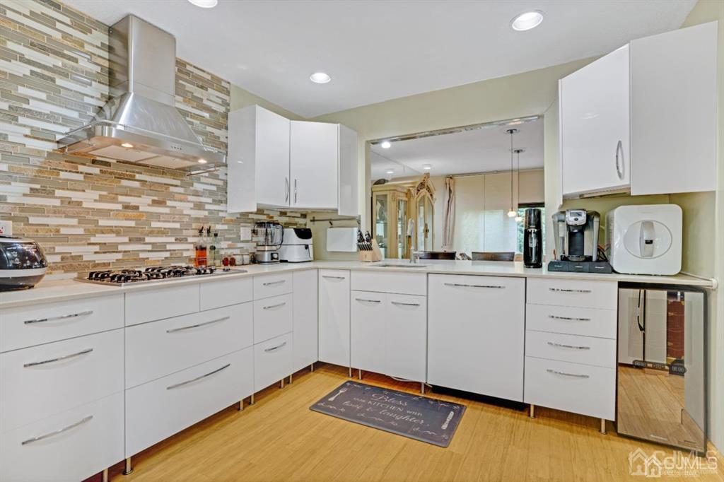 55 Gate House Lane Edison, NJ 08820 - Photo 11 of 28 a kitchen with stainless steel appliances white cabinets and a refrigerator