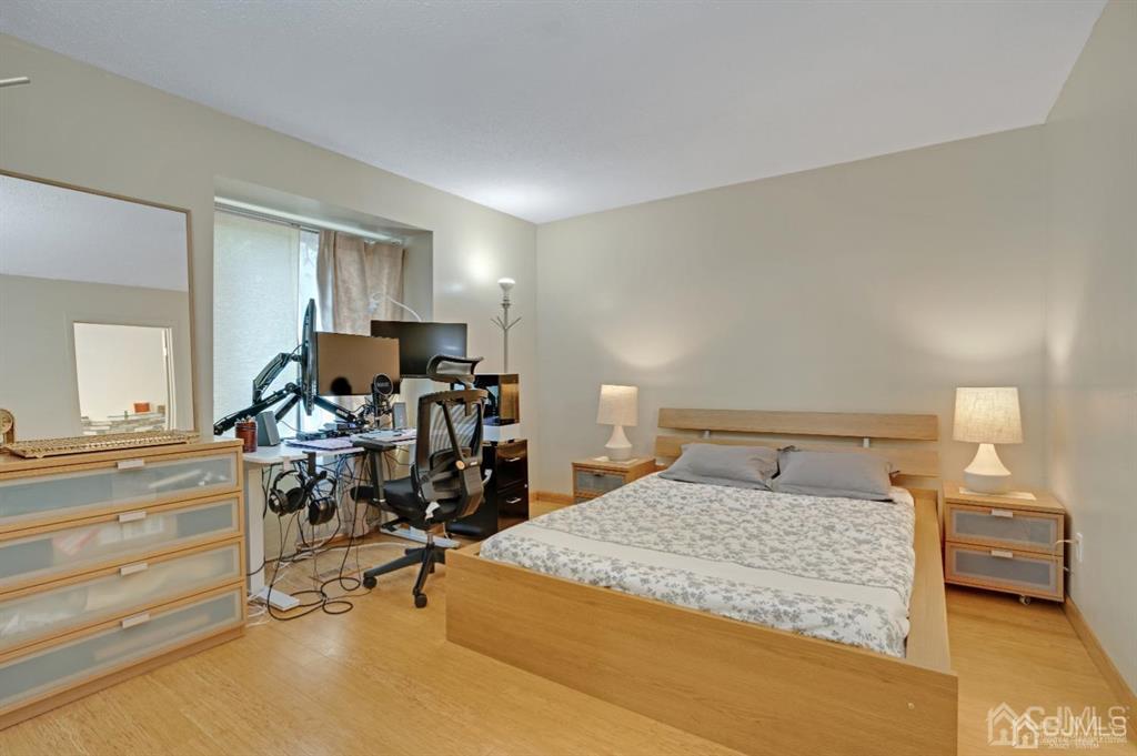 55 Gate House Lane Edison, NJ 08820 - Photo 17 of 28 a bedroom with a bed a table and chair