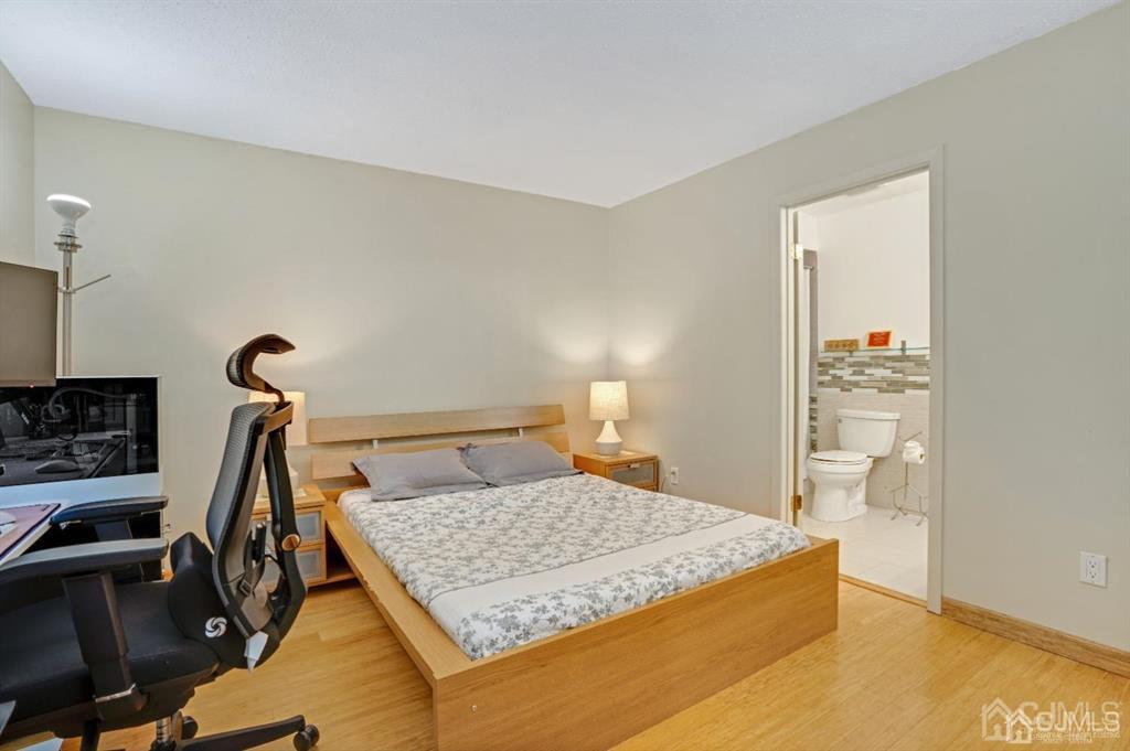 55 Gate House Lane Edison, NJ 08820 - Photo 18 of 28 a bedroom with a bed and wooden floor