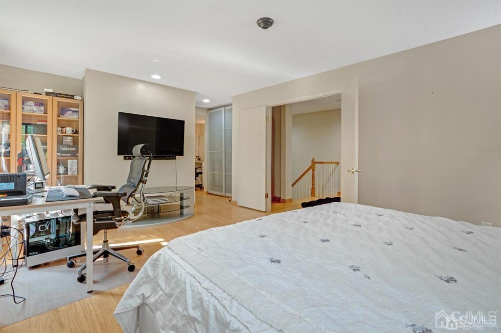 55 Gate House Lane Edison, NJ 08820 - Photo 21 of 28 a bedroom with a bed and a flat screen tv