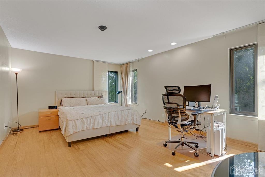 55 Gate House Lane Edison, NJ 08820 - Photo 22 of 28 a living room with a couch and a flat screen tv