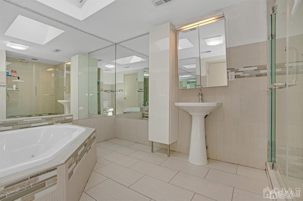 55 Gate House Lane Edison, NJ 08820 - Photo 23 of 28 a bathroom with a sink a toilet and shower