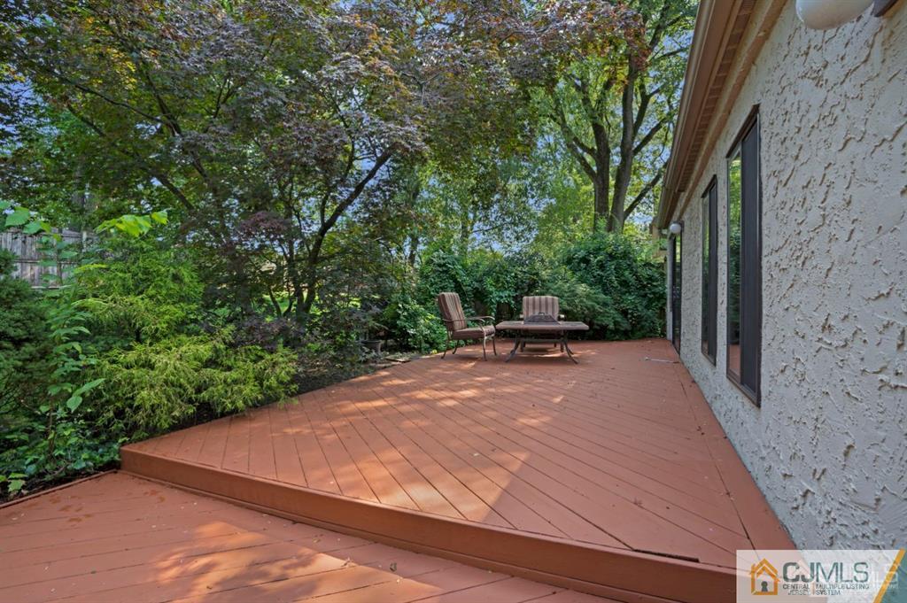 55 Gate House Lane Edison, NJ 08820 - Photo 27 of 28 a view of a patio with lawn chairs under an umbrella