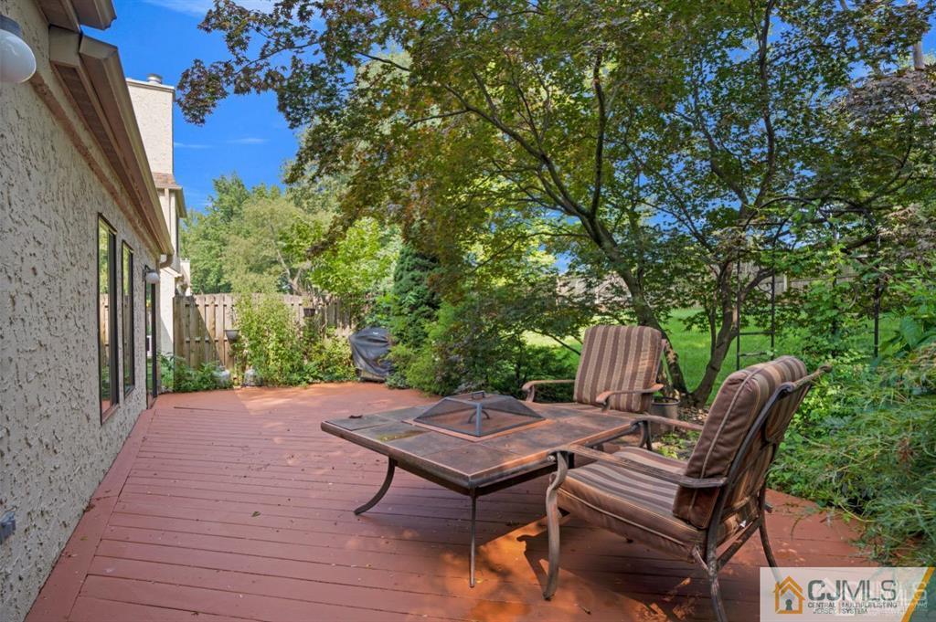 55 Gate House Lane Edison, NJ 08820 - Photo 28 of 28 a view of a patio with table and chairs with wooden floor and fence