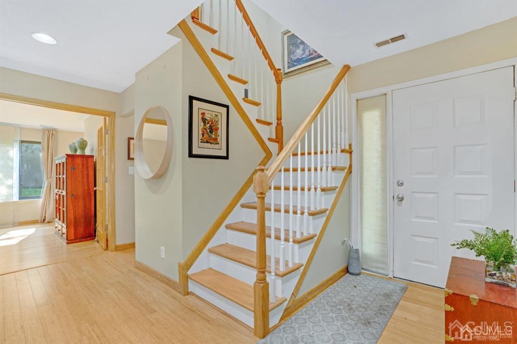 55 Gate House Lane Edison, NJ 08820 - Photo 4 of 28 a view of entryway with wooden floor and stairs