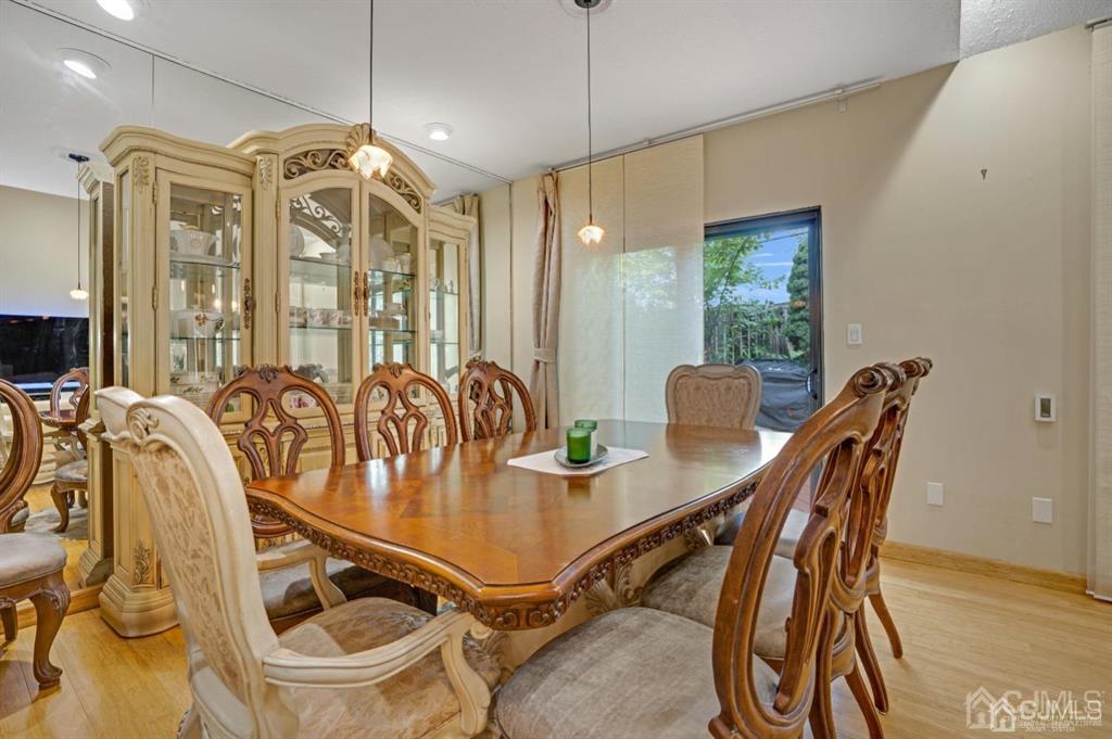 55 Gate House Lane Edison, NJ 08820 - Photo 9 of 28 a view of a dining room with furniture a chandelier and wooden floor