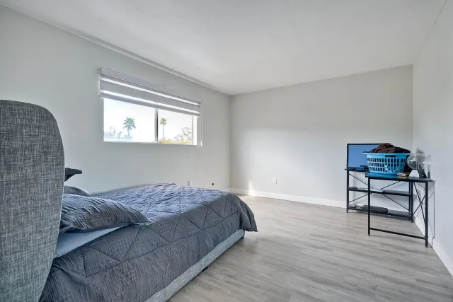 a bedroom with bed and a window