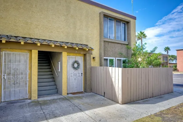 a view of a house with entryway and wooden wall