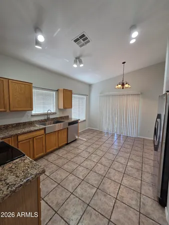 a kitchen with stainless steel appliances granite countertop a sink stove and cabinets