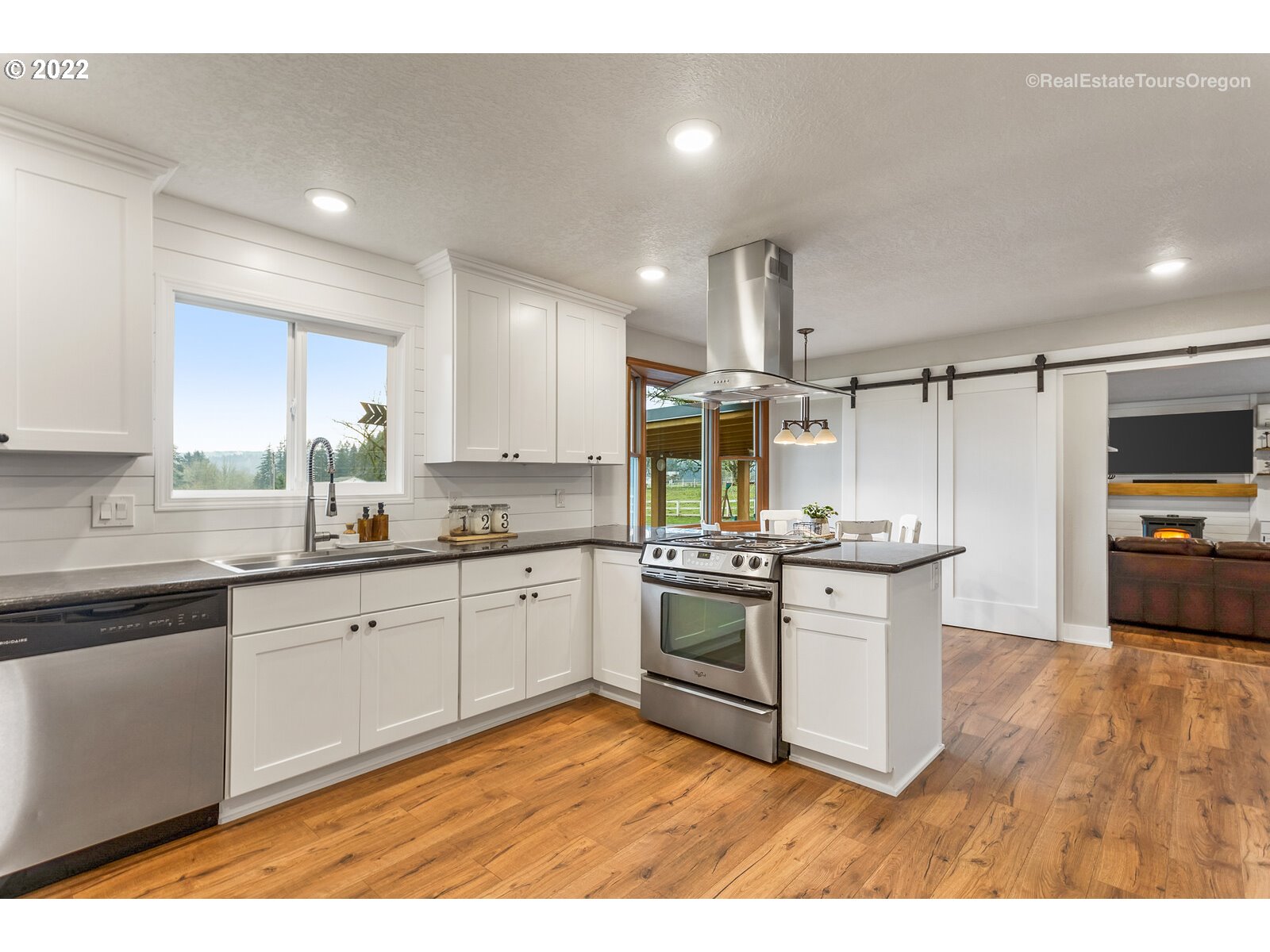 31980 Southwest Unger Road Cornelius, OR 97113 - Photo 8 of 9 a kitchen with stainless steel appliances granite countertop a stove a sink and a refrigerator