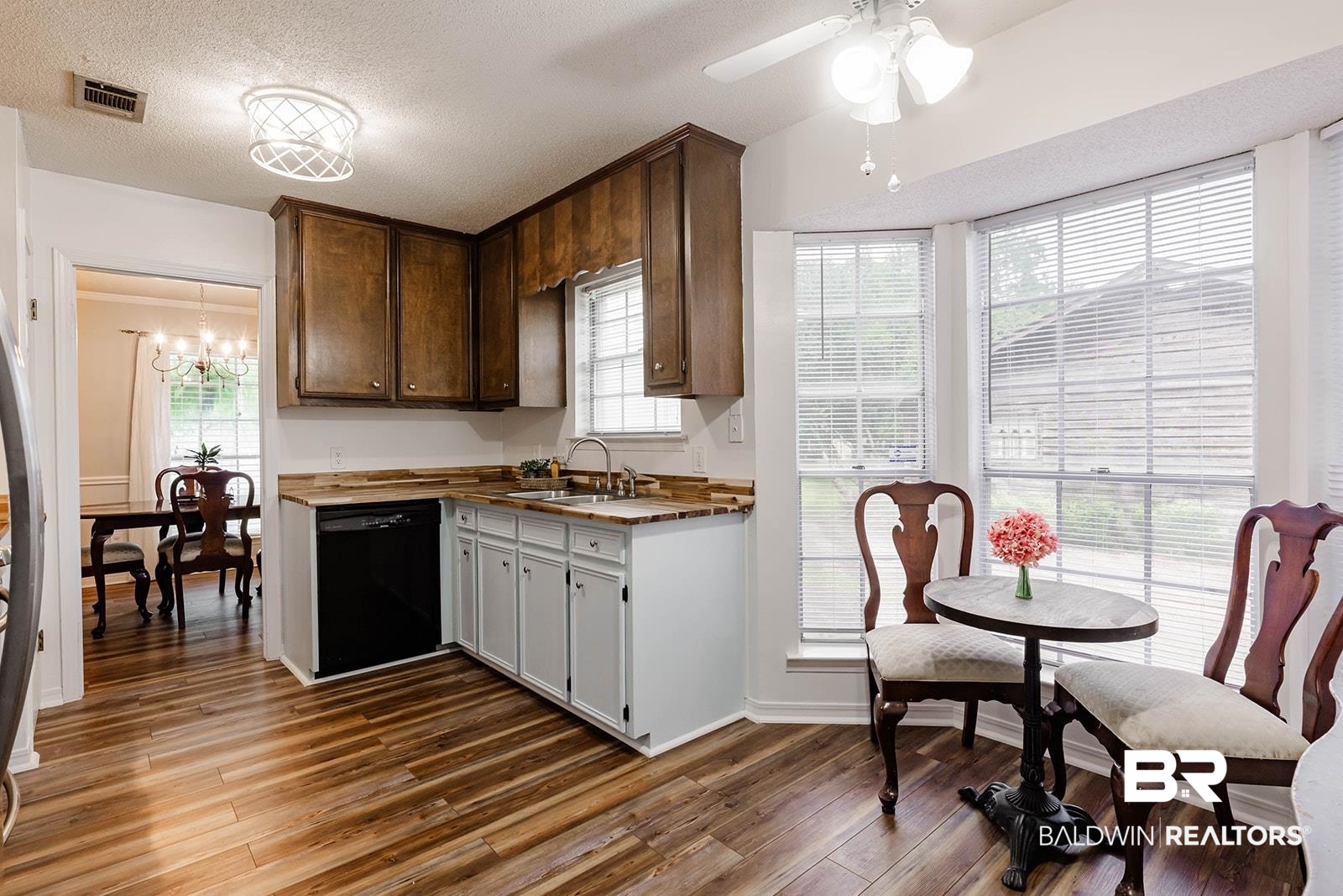 2920 Quail Creek Run Mobile, AL 36695 - Photo 14 of 33 Kitchen with black dishwasher, wood finished floors, a chandelier, a ceiling fan, and plenty of natural light