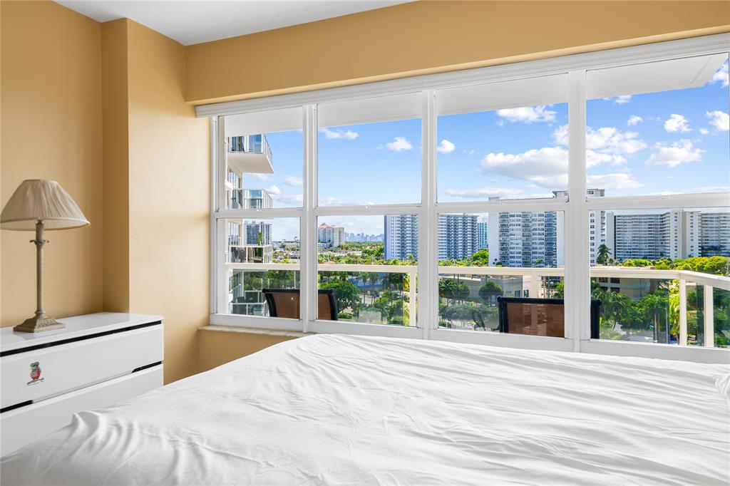 3700 Galt Ocean Drive, Unit 714 Fort Lauderdale, FL 33308 - Photo 11 of 39 a bedroom with a large window and a table