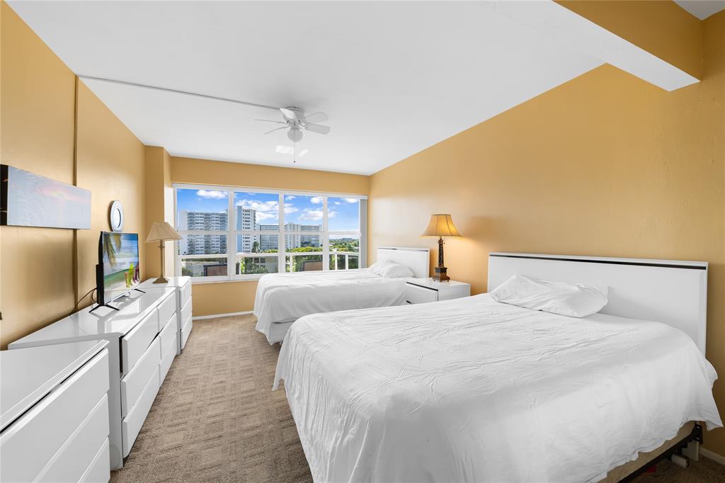 3700 Galt Ocean Drive, Unit 714 Fort Lauderdale, FL 33308 - Photo 12 of 39 a bedroom with a large bed and a flat tv screen on dresser