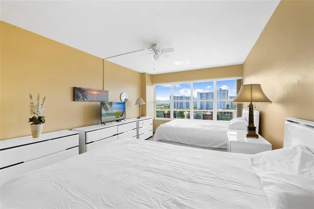 a large bedroom with a large bed and large window