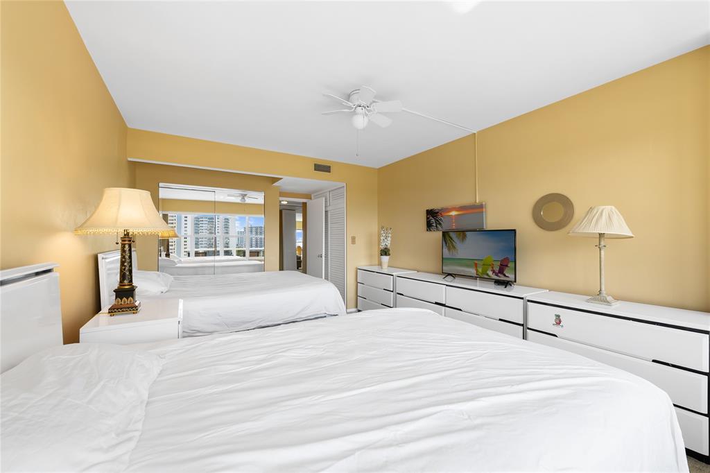 3700 Galt Ocean Drive, Unit 714 Fort Lauderdale, FL 33308 - Photo 14 of 39 a bedroom with a bed and a large mirror on the dresser