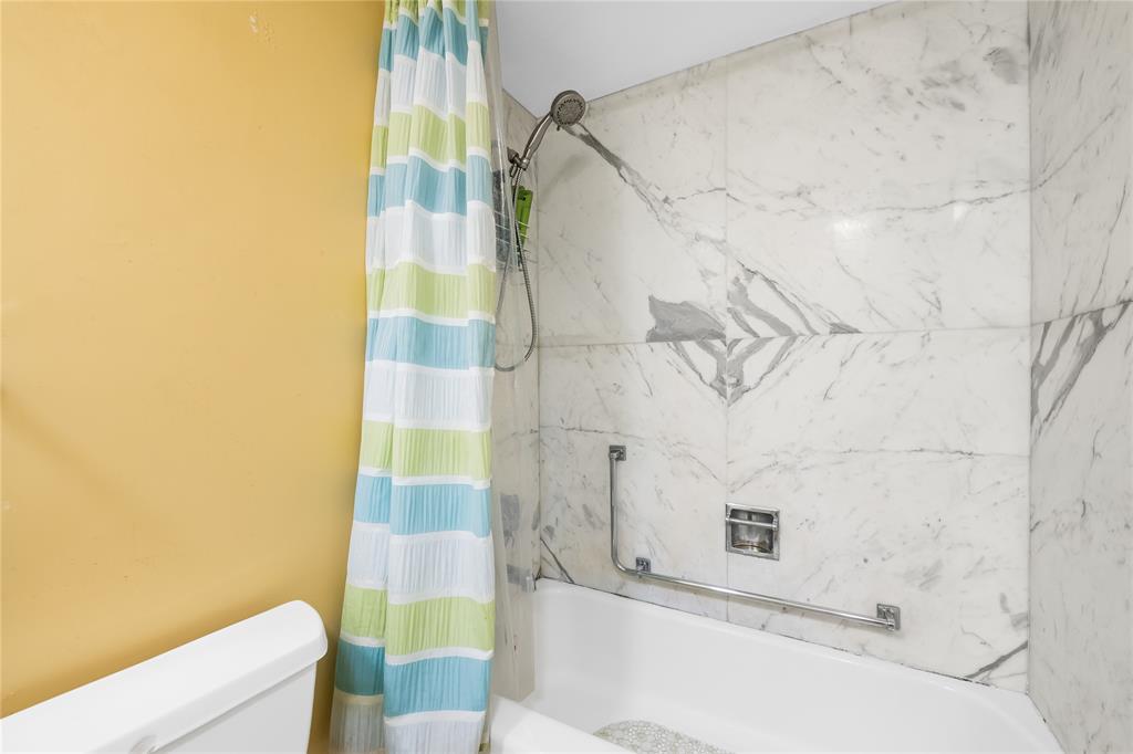 3700 Galt Ocean Drive, Unit 714 Fort Lauderdale, FL 33308 - Photo 18 of 39 a bathroom with a bathtub and shower