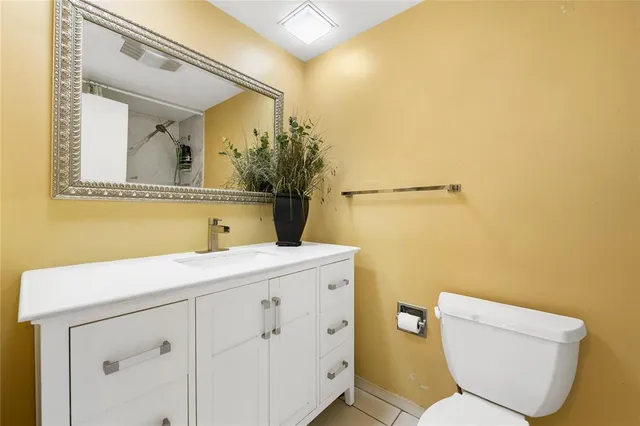 a bathroom with a sink a toilet and mirror