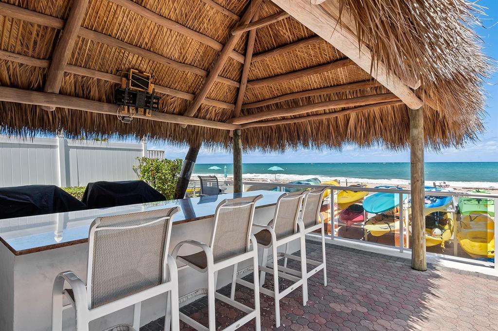 3700 Galt Ocean Drive, Unit 714 Fort Lauderdale, FL 33308 - Photo 34 of 39 a view of a patio with table and chairs potted plants