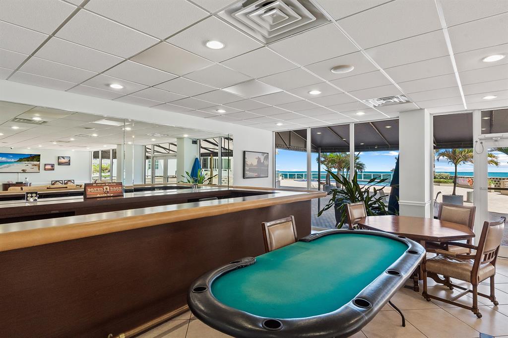 3700 Galt Ocean Drive, Unit 714 Fort Lauderdale, FL 33308 - Photo 36 of 39 a room with wooden floors pool table and chairs