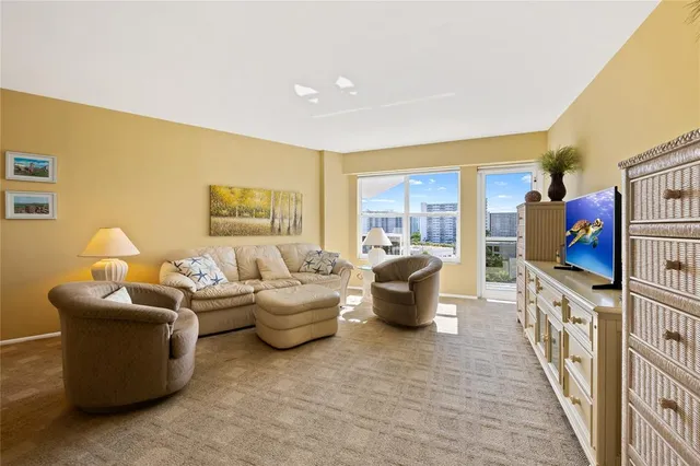 a living room with fireplace furniture and a flat screen tv
