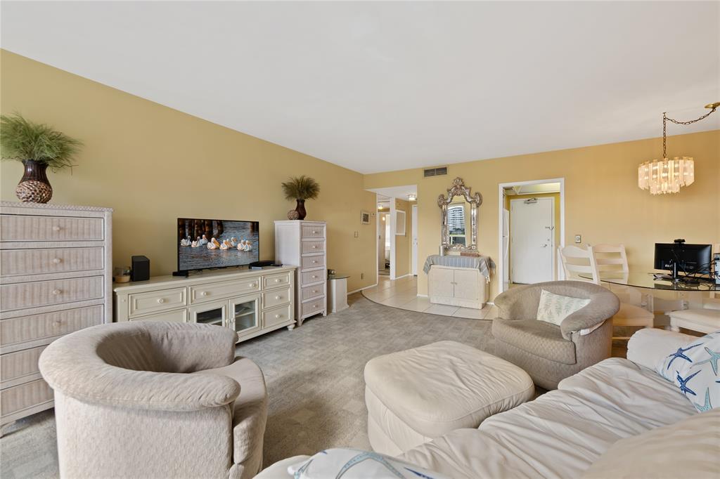 3700 Galt Ocean Drive, Unit 714 Fort Lauderdale, FL 33308 - Photo 9 of 39 a living room with furniture and a flat screen tv