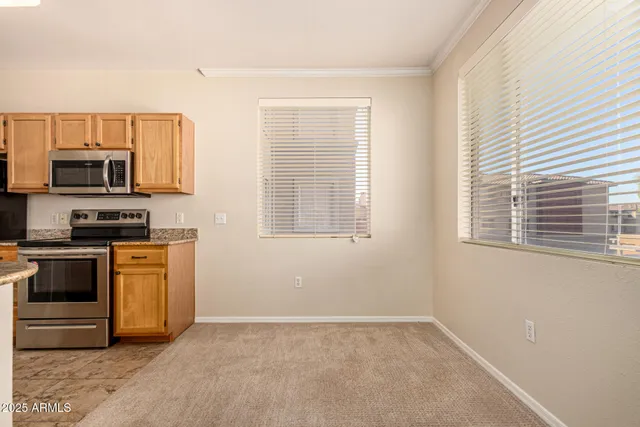 a kitchen with granite countertop a stove a sink and a microwave