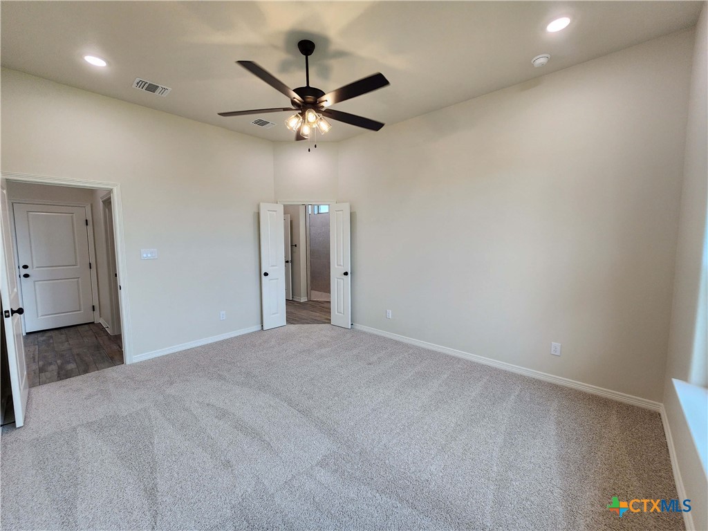 406 Talon Loop Salado, TX 76571 - Photo 19 of 31 a view of a big room with a chandelier fan and windows