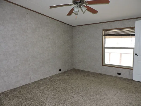 an empty room with windows and closet