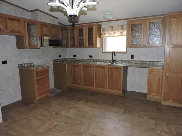 a view of a kitchen with a sink and a refrigerator