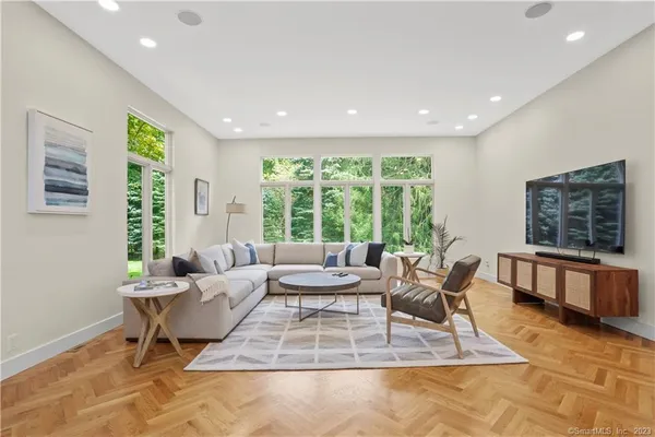 a living room with furniture and large windows
