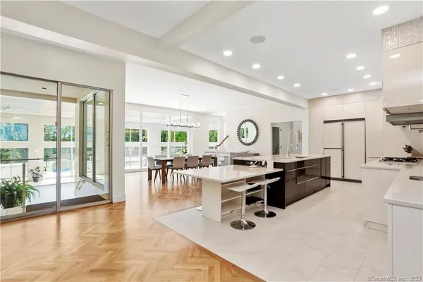 a room with lots of table chair and a large window