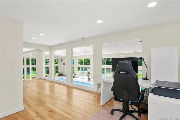 a living room with furniture and a floor to ceiling window