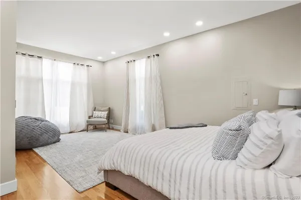 a bedroom with a bed and a chair