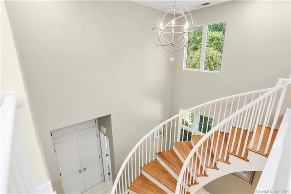 a view of entryway and hall with wooden floor