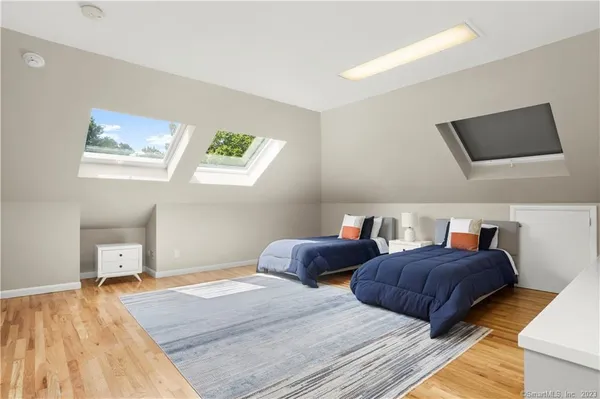 a bedroom with two beds and a window