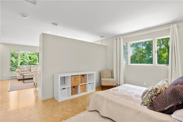 a bedroom with a bed and a large window