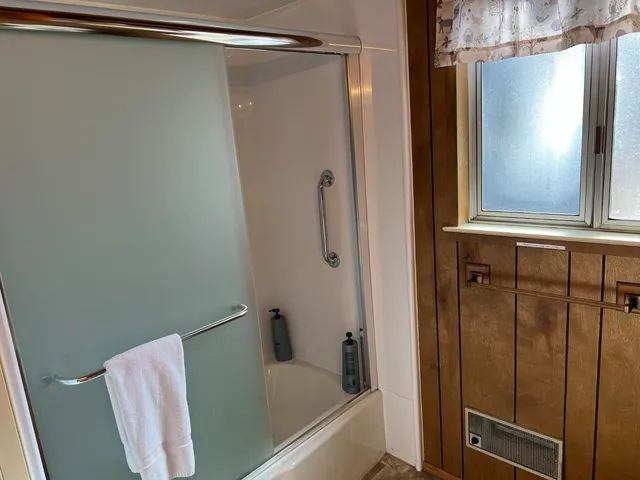 a bedroom with a large bed and a window