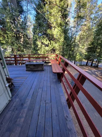 a sitting area with wooden floor and trees