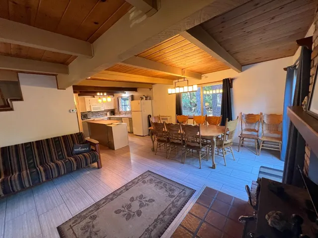 a dining room with furniture and wooden floor
