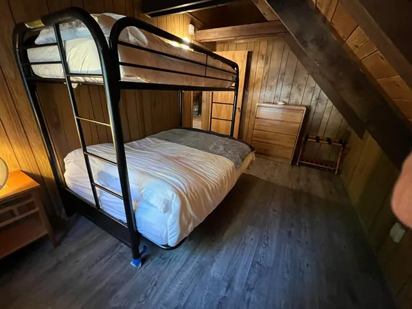 a bed sitting in a room next to a window