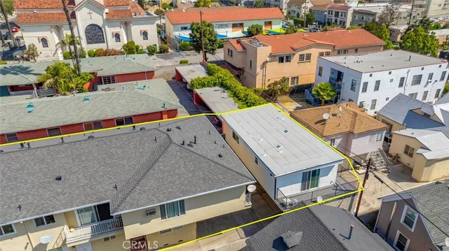 an aerial view of residential houses with outdoor space and street view